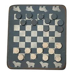 a chess board with metal pieces on it and some coins sitting on top of the board