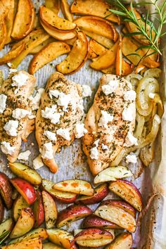 chicken, potatoes and herbs on a baking sheet with some seasoning in the middle