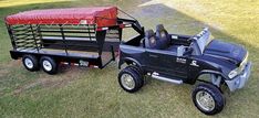 a black truck with a red cover on it and a blue trailer attached to it