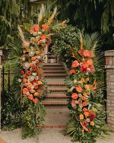 an archway decorated with flowers and greenery