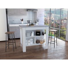 a kitchen island with two stools in front of it and a window overlooking the city