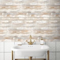 a white sink sitting under a wooden wall