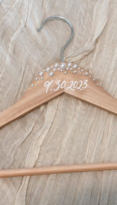 a wooden hanger with the word bride written on it