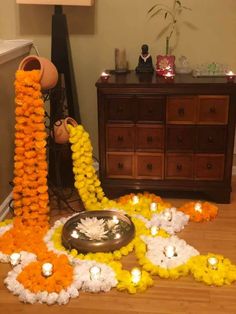 an arrangement of flowers and candles on the floor