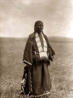 Two Charger Woman - Sicangu Lakota - 1907    {Note: In her right hand she holds a decorated horse quirt with a serrated edge. This would nomally be something carried by a member of a warrior society.} American Woman, Native Art