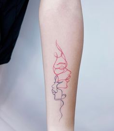 a woman's leg with a tattoo on her left arm and the word love written in red ink