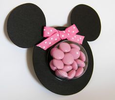 a mickey mouse head with pink candy in the shape of a bow on it's ear