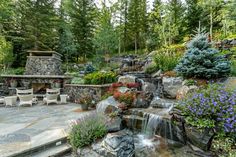 an outdoor patio with waterfall and seating area