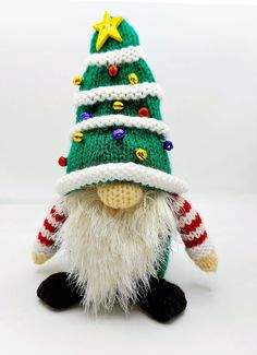 a knitted christmas gnome with a green and white hat