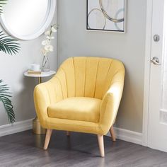 a yellow chair sitting in front of a mirror