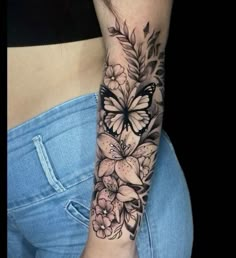 a woman's arm with flowers and butterflies on the left side of her body