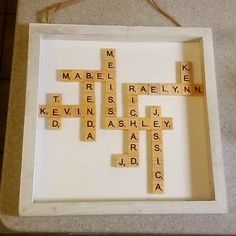 scrabbles are arranged in a white frame on the floor, which is decorated with words