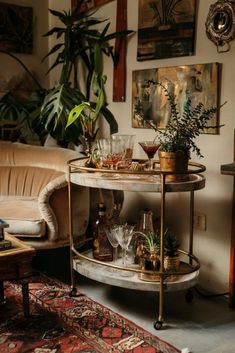 a living room filled with furniture and lots of plants on top of a round table