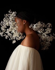 a woman with white flowers in her hair