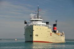 a large white and red boat in the water