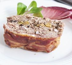 a piece of meat sitting on top of a white plate