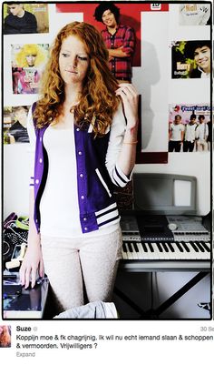 a woman standing in front of a piano