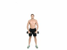 a man with no shirt is holding two dumbbells in front of his body