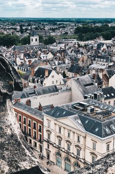 an aerial view of a city with tall buildings and steeple tops in the foreground