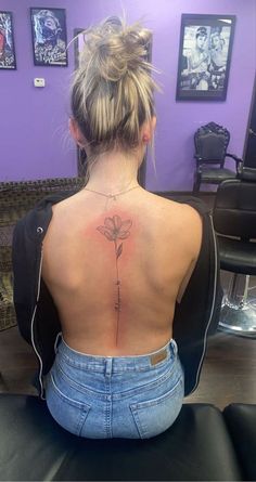 a woman with a flower tattoo on her back