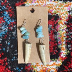 the earrings are made out of horns and turquoise beads with silver earwires