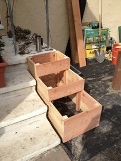 three wooden boxes sitting on top of steps