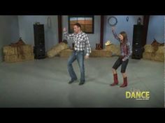 a man and woman dancing in a room with hay bales