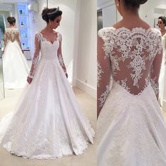 the back of a wedding dress with long sleeves and lace on it, is shown