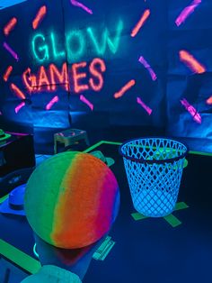 neon lights are projected on the wall behind a table with bowls and baskets in front of it