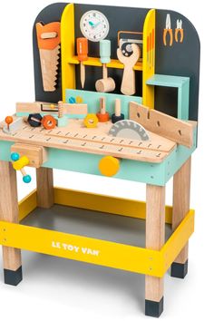 a wooden toy work bench with tools on it