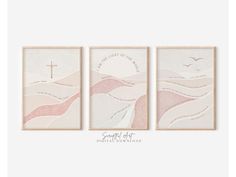 three pink and white paintings with a cross on them