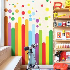 a child's room with colorful wallpaper and toys on the shelves in front of it