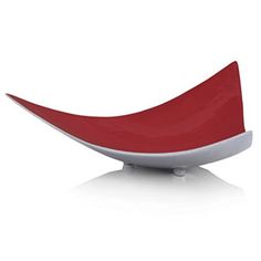 a red and white bowl sitting on top of a table