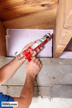 a man is painting the ceiling with red paint