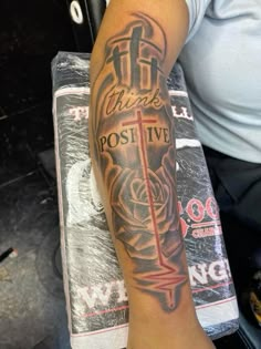 a man's arm with a cross and roses tattoo on it, which reads thank post live