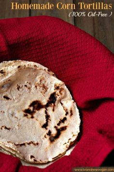 homemade corn tortillas on a red cloth with text overlay that reads homemade corn tortillas