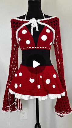 a red and white crochet dress on a mannequin head stand with a video