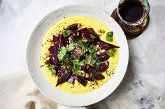 a white bowl filled with food on top of a table