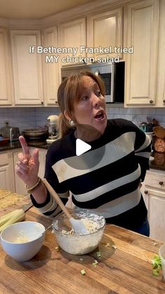 a woman making a face while mixing food in a bowl on top of a kitchen counter