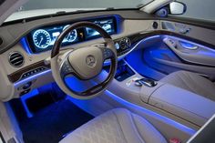 the interior of a car is lit up with blue lights