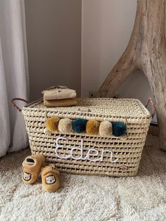 a wicker basket sitting on top of a floor next to a pair of shoes