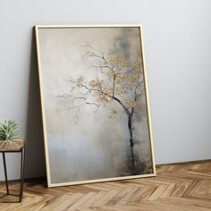 a painting on the wall next to a small table with a potted plant in it