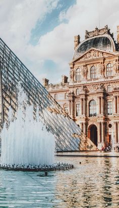 a large building with a fountain in front of it