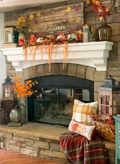 a fireplace decorated with fall decorations and pumpkins