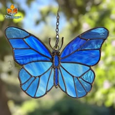 a stained glass butterfly hanging from a chain