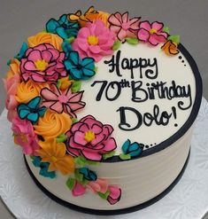 a birthday cake decorated with flowers and the words happy 70th birthday dojo on it