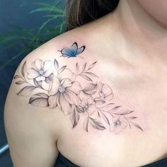 a woman's chest with flowers and a butterfly tattoo on her left side shoulder