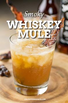 a close up of a drink on a table with the words smokey whiskey mule