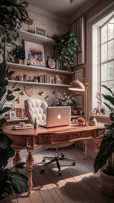 a laptop computer sitting on top of a wooden desk in front of a large window