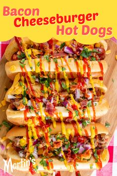 bacon cheeseburger hot dogs on a cutting board with ketchup and mustard